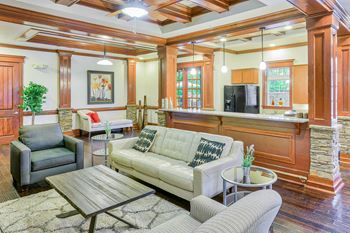 A living room with a couch, chair, and coffee table.